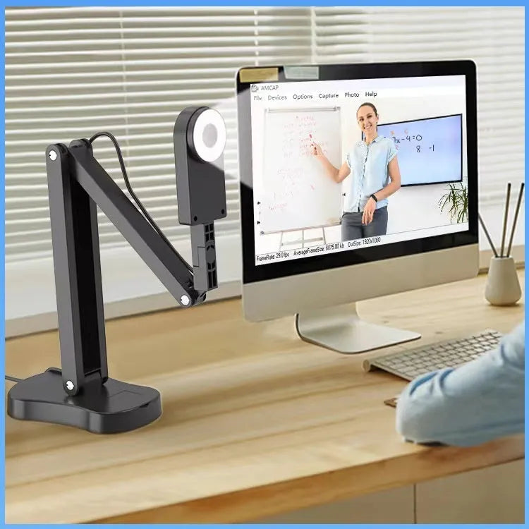 Computer webcam with microphone showing USB cable connection and compact design