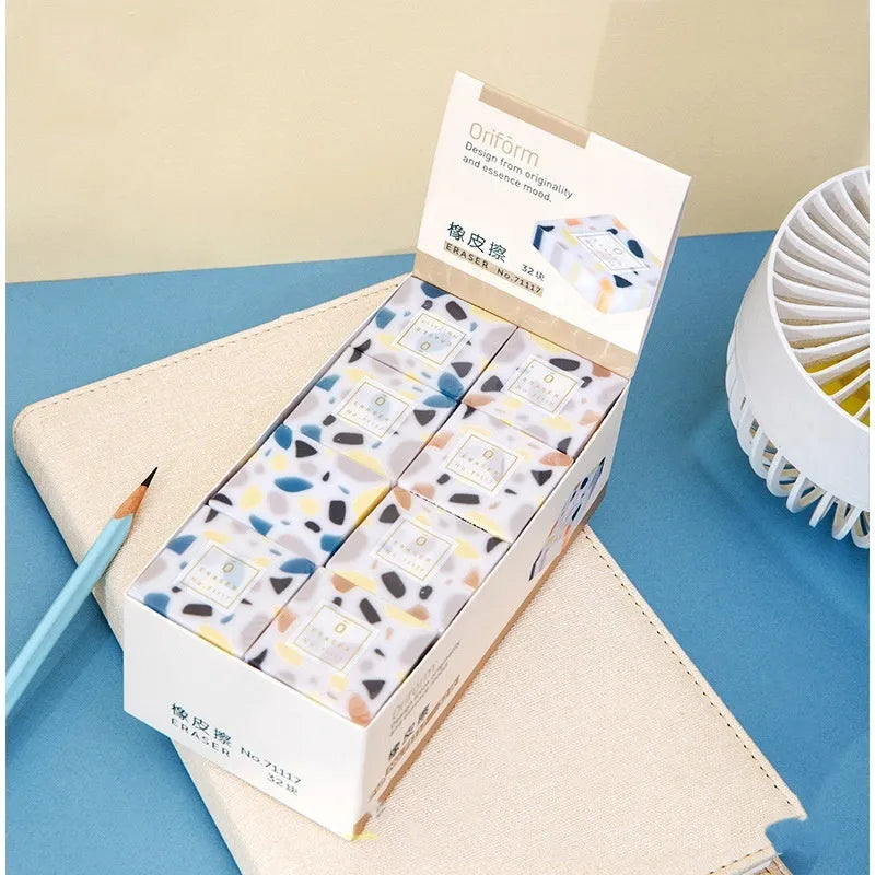 A white brick-shaped soft rubber eraser for traceless pencil correction.
