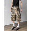 Yellow denim jeans with a snake camouflage pattern and cropped leg hem.