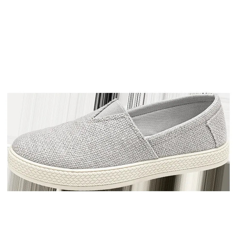 Men's beige linen cloth slip-on shoes with a round toe and shallow mouth on a grey background.