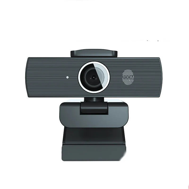 Black 4K USB webcam with attached cable and a magnetic privacy cover on a desk.