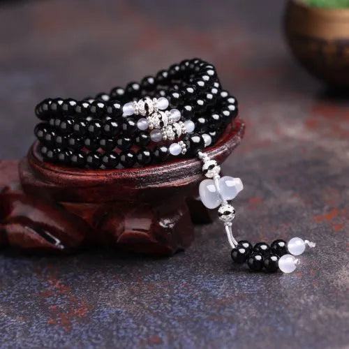 Black agate bracelet with 108 geometric natural stone beads on adjustable fastening