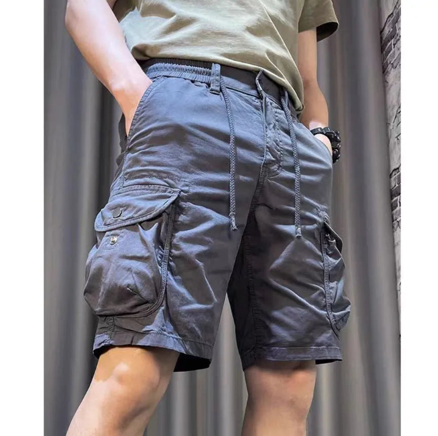 Loose straight-leg Korean-style casual overalls in khaki with multiple pockets on a neutral background.