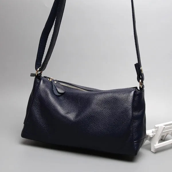 A soft genuine leather women's crossbody bag in a horizontal square shape, shown in one of four available colours.