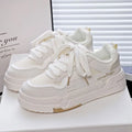 Beige children's lace-up board shoes with cross shoulder straps and a thick rubber sole, shown on a white background.