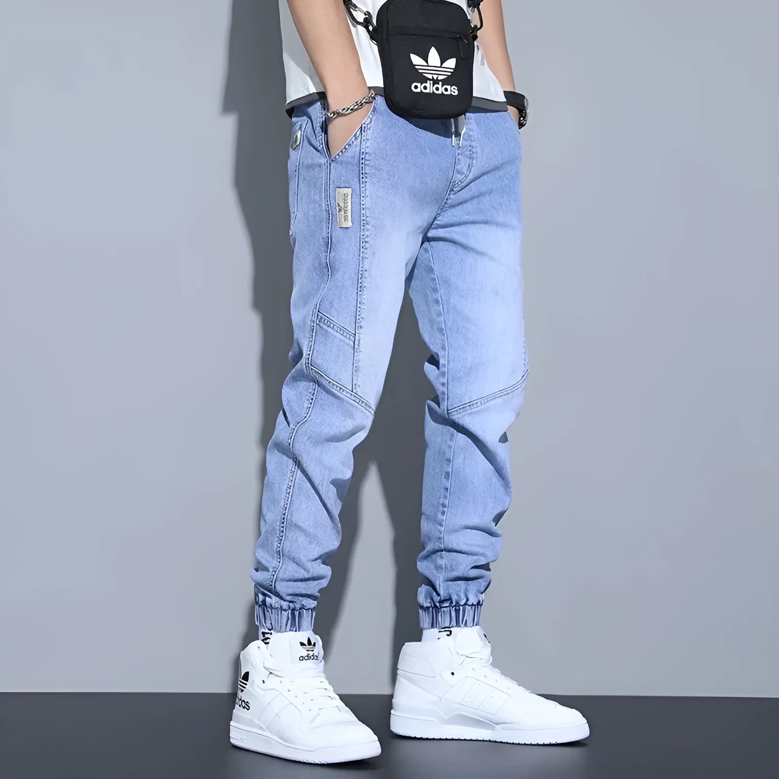 Men's slim fit straight-leg jeans in blue denim with high waist and ankle-tied style