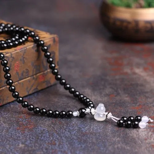 Black agate bracelet with 108 geometric natural stone beads on adjustable fastening