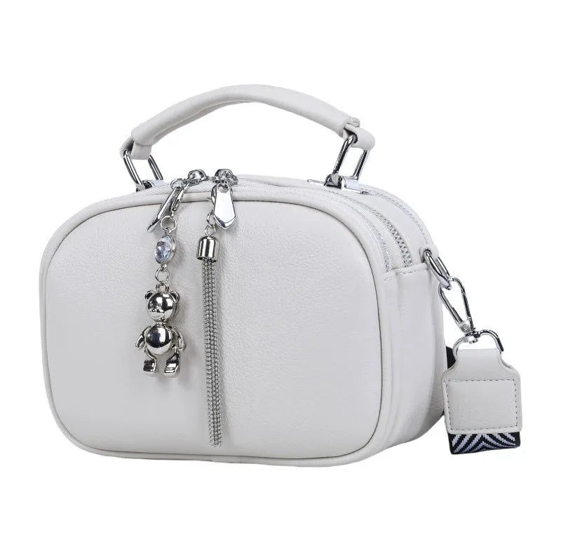 Women's small square bag with stitching detail showing oval shape and double shoulder straps