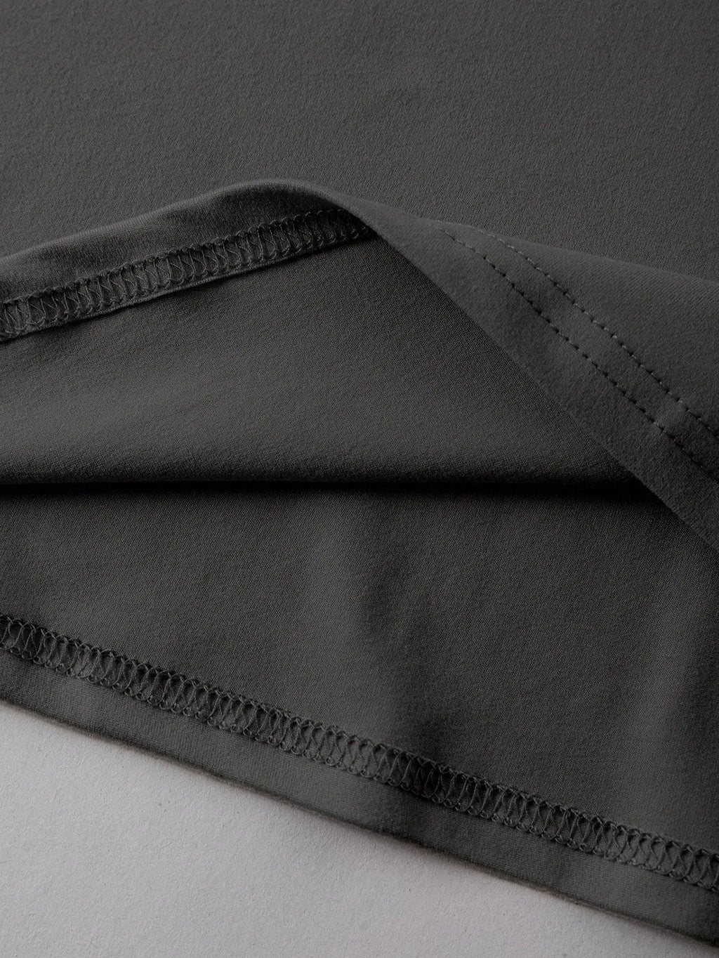 Straight cut loose summer t-shirt in cotton fabric on a hanger.
