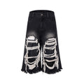 Black wide leg cropped jeans with distressed patch details on the legs, showing a mid-high waist.