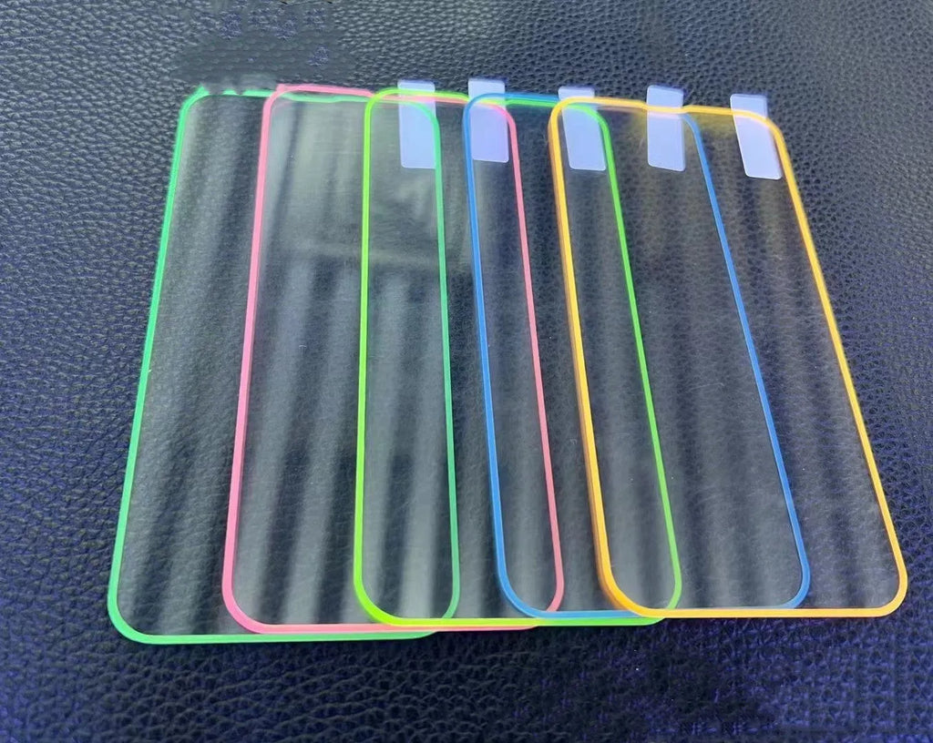 Fluorescent tempered glass screen protector glowing on an iPhone 13, showing pink luminous edge and precise camera cutout.