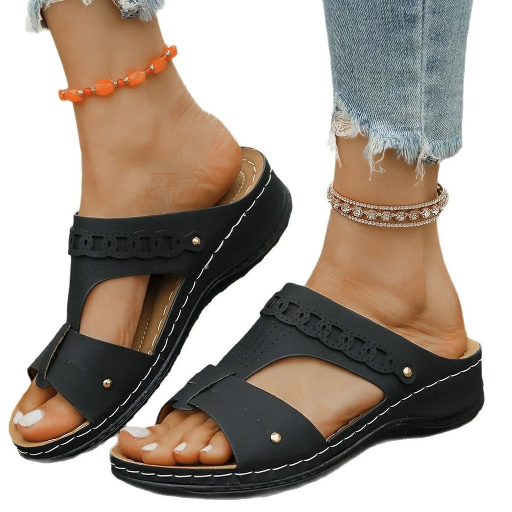 Pair of casual Roman style slippers with a fish mouth toe holder and slope heel, shown in a choice of colours.