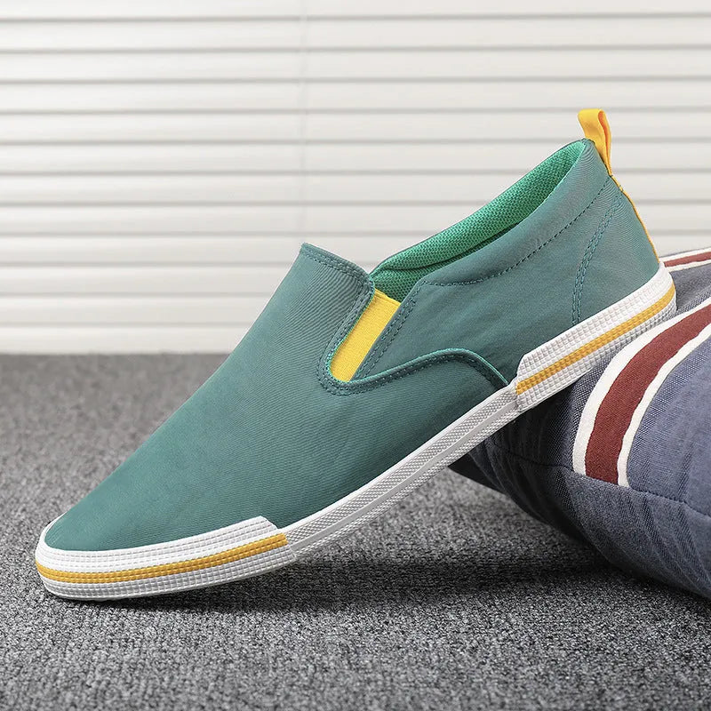 Men's low-top canvas sneakers in grey, black orange, or khaki with a vulcanised rubber sole.