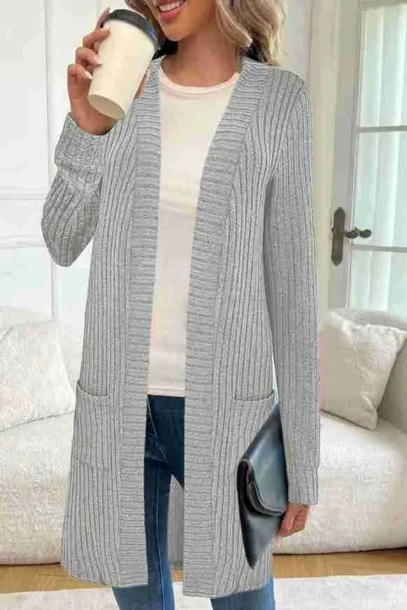 Long sleeve loose fit knitted cardigan jacket in black, shown on a hanger.