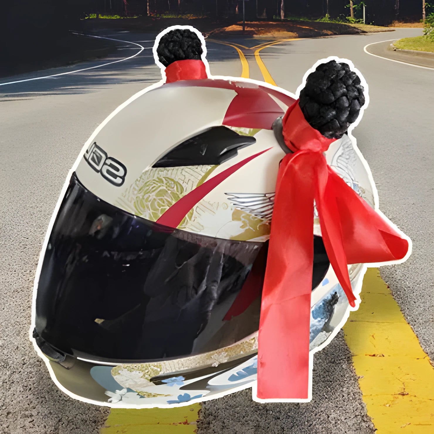 Pair of black helmet braid accessories with 5cm diameter balls next to a non-marking adhesive strip on a table.