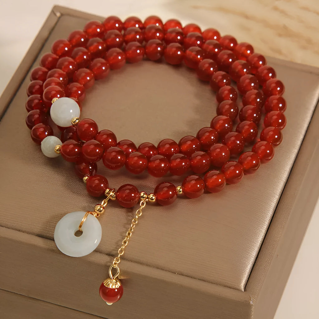 Red agate multi-layer crystal bracelet with a retro ethnic style on a white background.