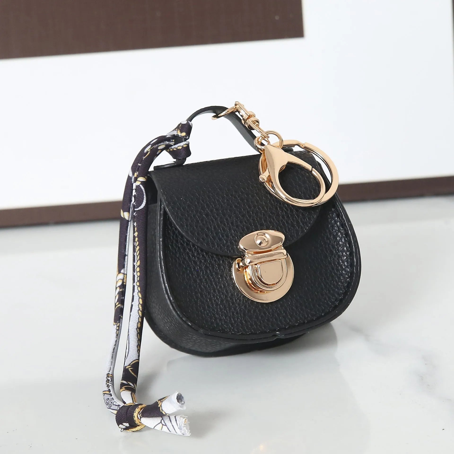 Small PVC coin purse keychain pendant in a solid colour, shown attached to a keyring.