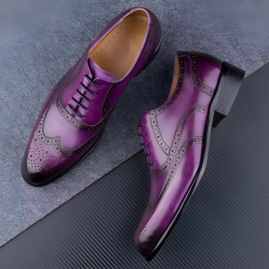 Men's purple leather Oxford dress shoes with hand-carved detail and pointed toe on a rubber sole.