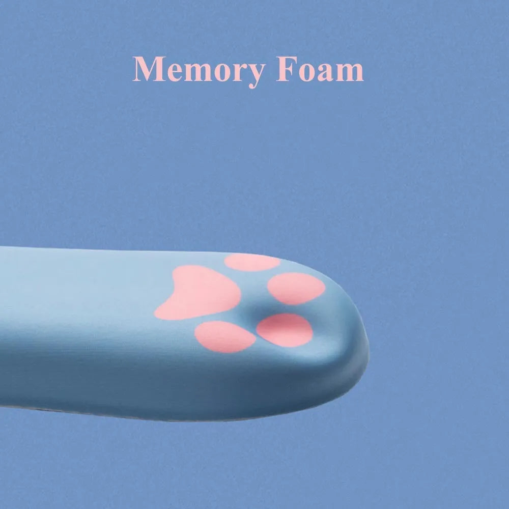 Blue memory foam keyboard wrist support pad on a wooden desk next to a keyboard.