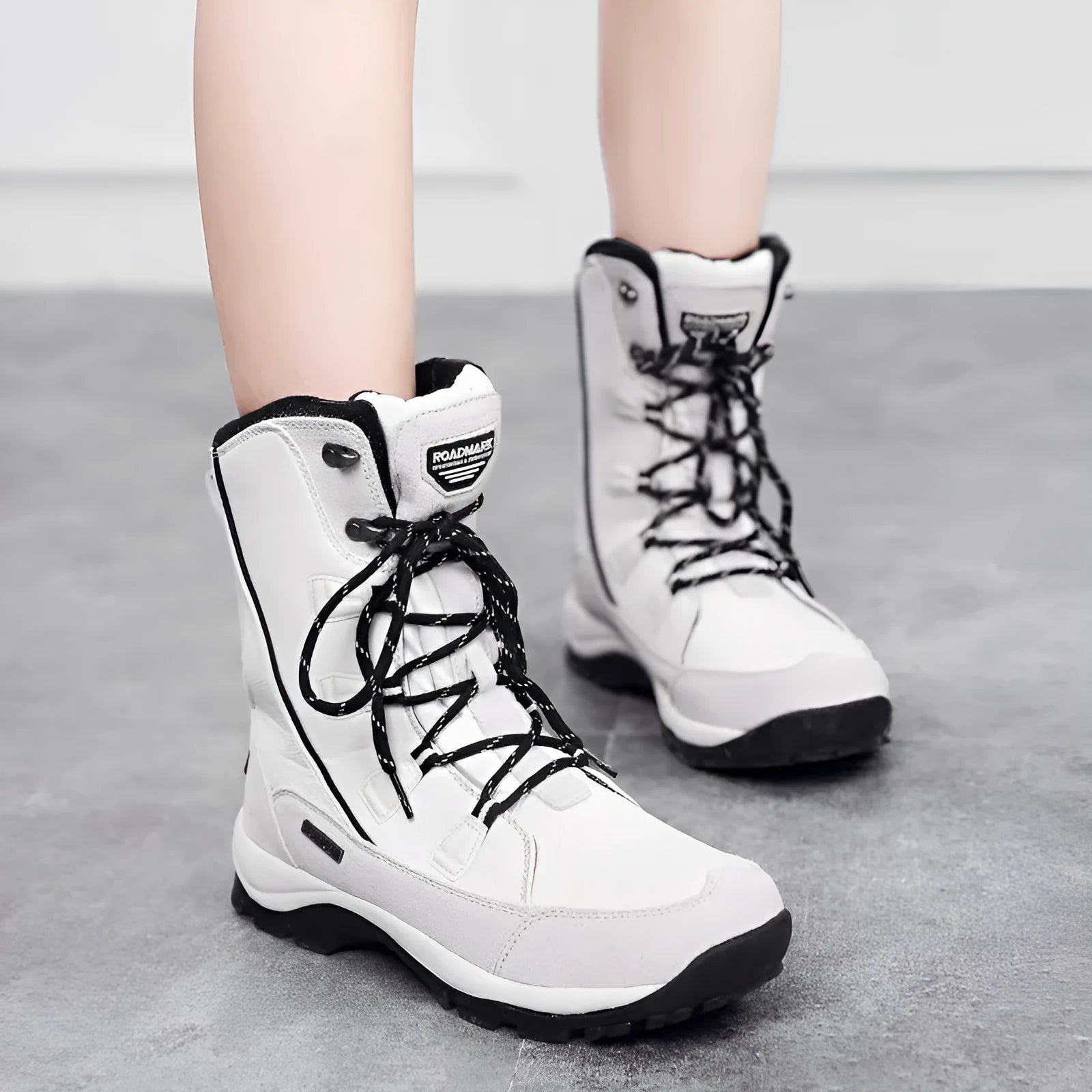 Women's black thermal snow boots with genuine leather uppers and a non-slip rubber sole.