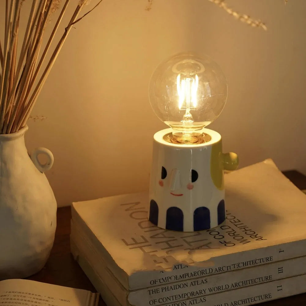 Handmade ceramic table lamp with a white spherical shade on a solid ceramic base, showcasing its simple design.