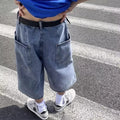 Blue washed denim men's shorts with a high waist and cropped, straight-leg pirate style.