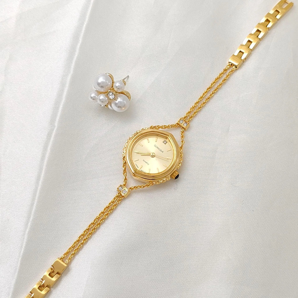 Gold and silver women's quartz watch with 25mm dial on a metal chain strap
