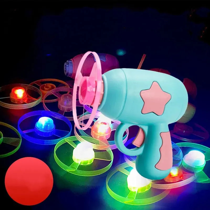 Blue LED flying saucer launcher toy set with gun, three luminous discs, and target board on packaging.