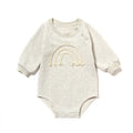 Infant wearing a beige waffle cotton long sleeve romper climbing suit