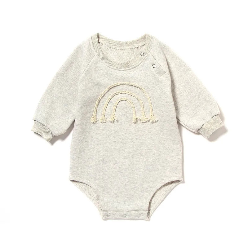Infant wearing a beige waffle cotton long sleeve romper climbing suit
