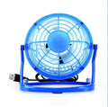 Mini adjustable tilt USB desk fan in black, shown on a desk next to a laptop