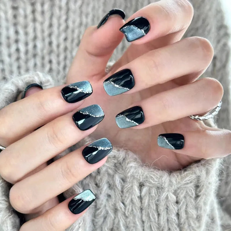 Sweet Girl Wearing Fake Nails set showing medium length coffin-shaped press-on nails with random colour designs.