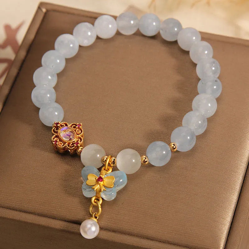 Women's aquamarine butterfly pendant crystal bracelet with rhinestone detailing on adjustable chain
