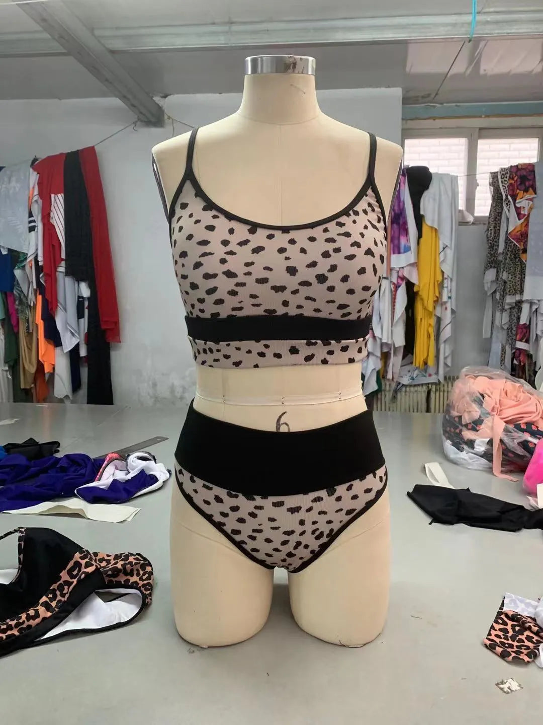 White and leopard print women's high waist bikini swimsuit with split briefs.