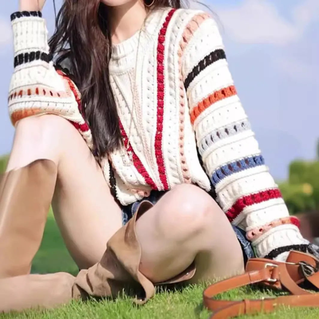 Multicolour rainbow striped women's sweater with batwing sleeves and a loose round neck fit.