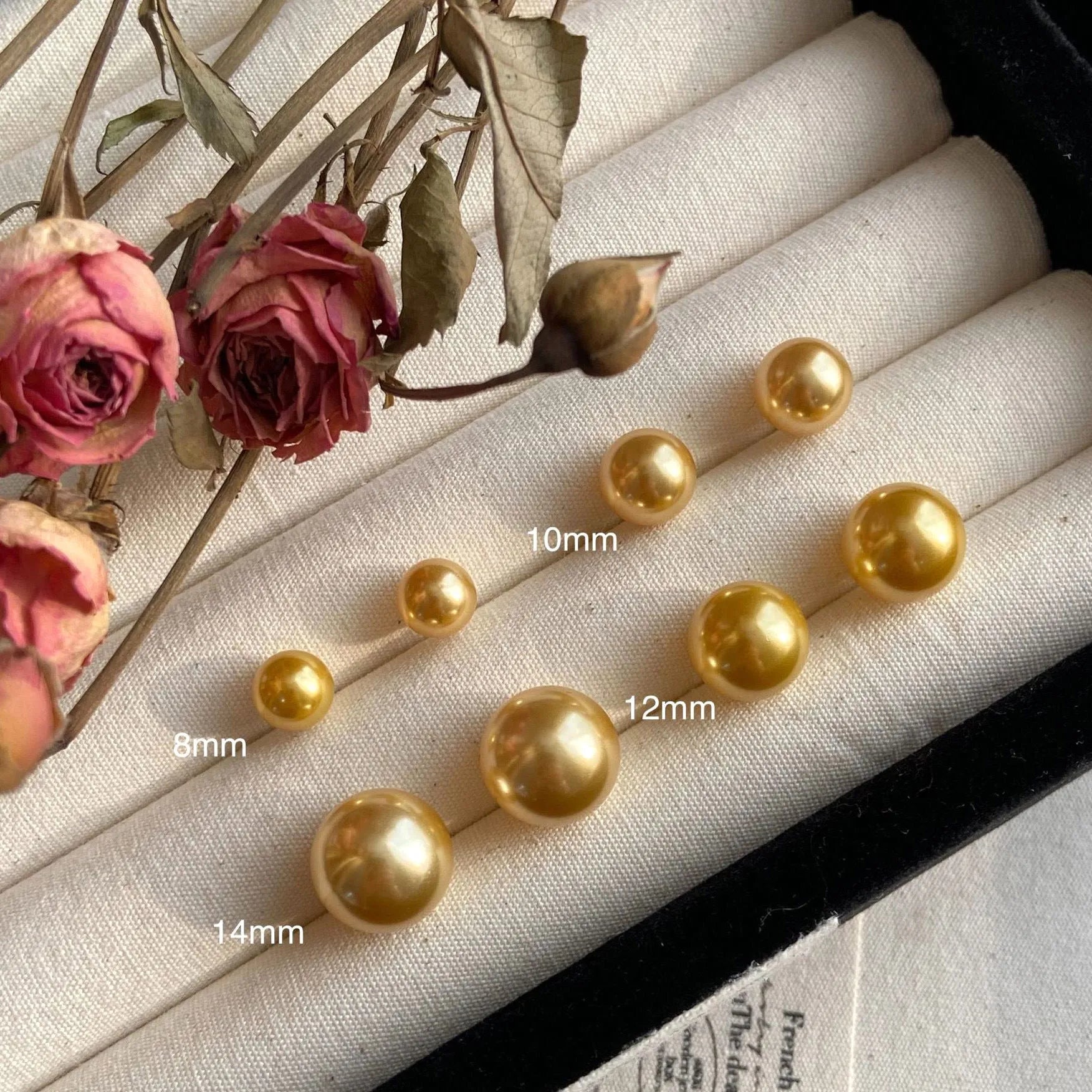 Close-up of a women's large pearl stud earring with an eight-point geometric silver star setting.