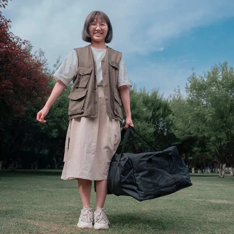 Green oversized waterproof storage bag for camping tables and chairs, shown folded and expanded.