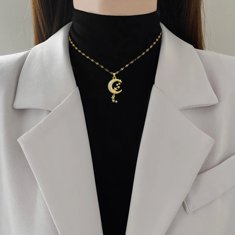 Geometric full moon pendant necklace with crystal setting and tassel on a stainless steel chain.
