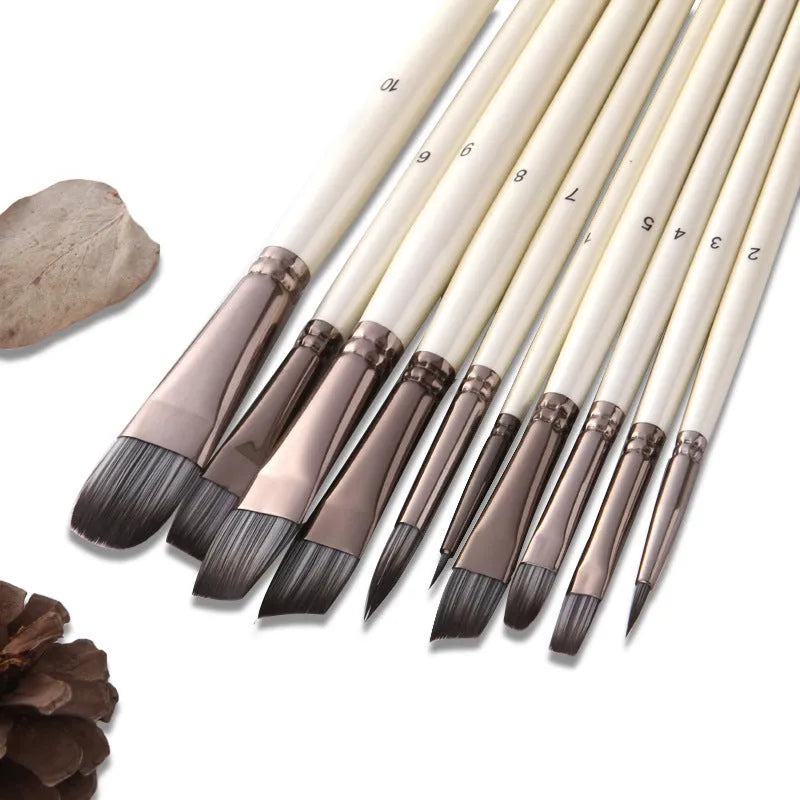 Set of ten pearl white nylon watercolour brushes with wood handles on a table.