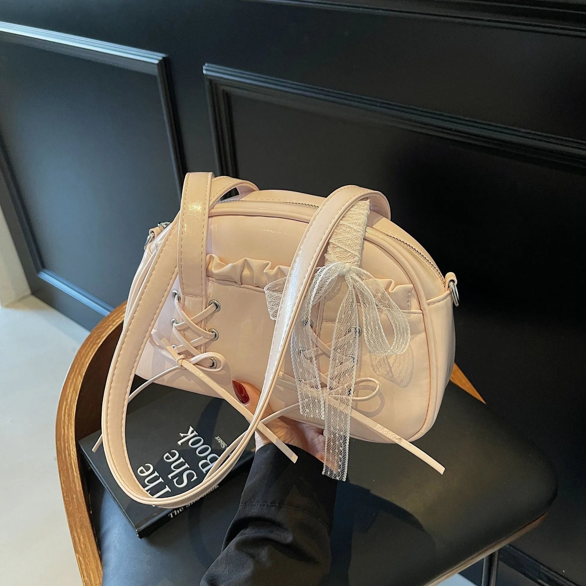 Women's casual PU leather shoulder bag with a bandage bow design and internal phone compartment.