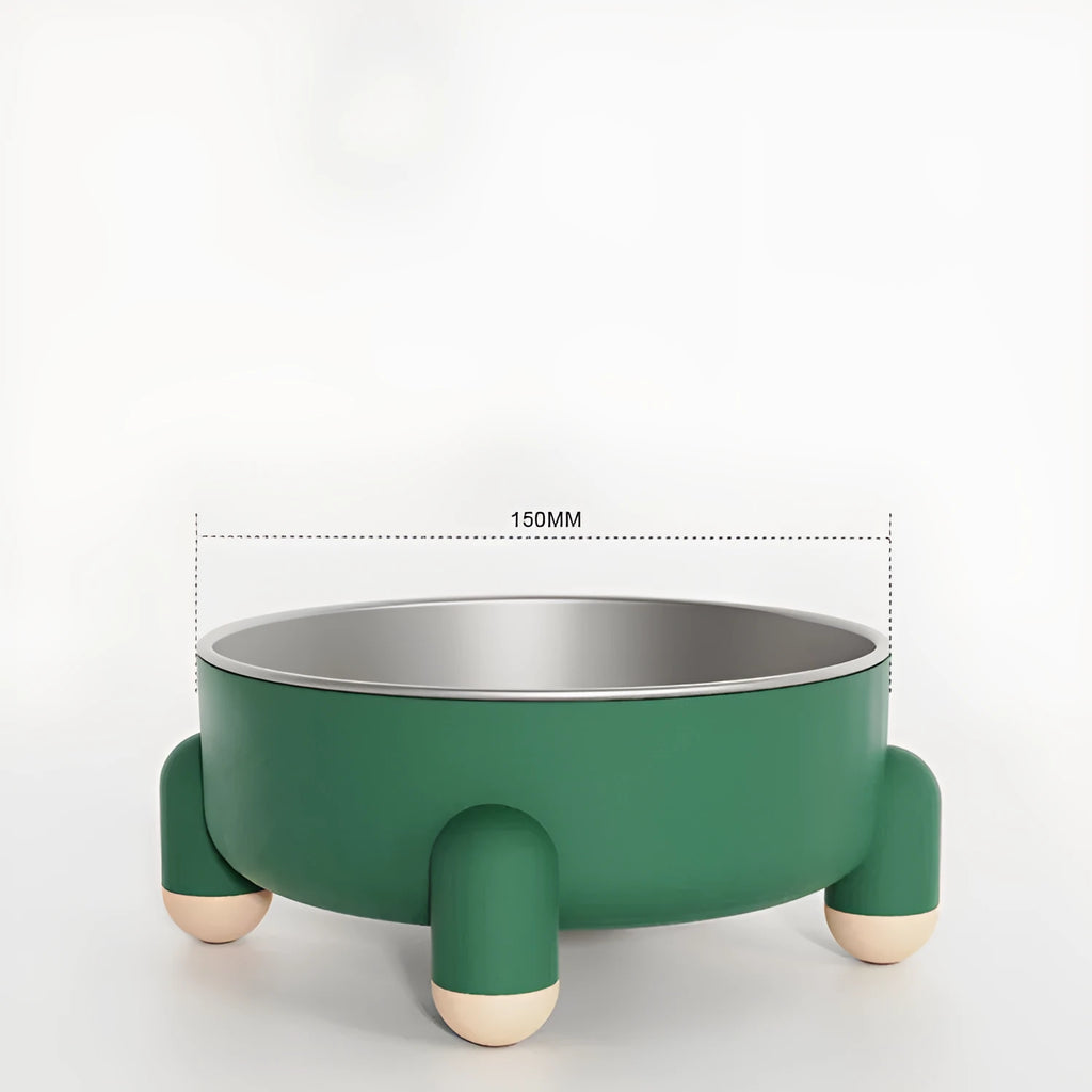 Green stainless steel pet bowl with non-slip base and raised high foot on a wooden floor.