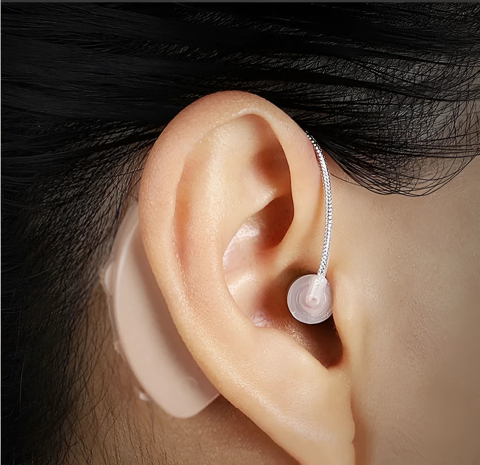 Black silicone rechargeable hearing aid amplifier with charging cable for elderly users