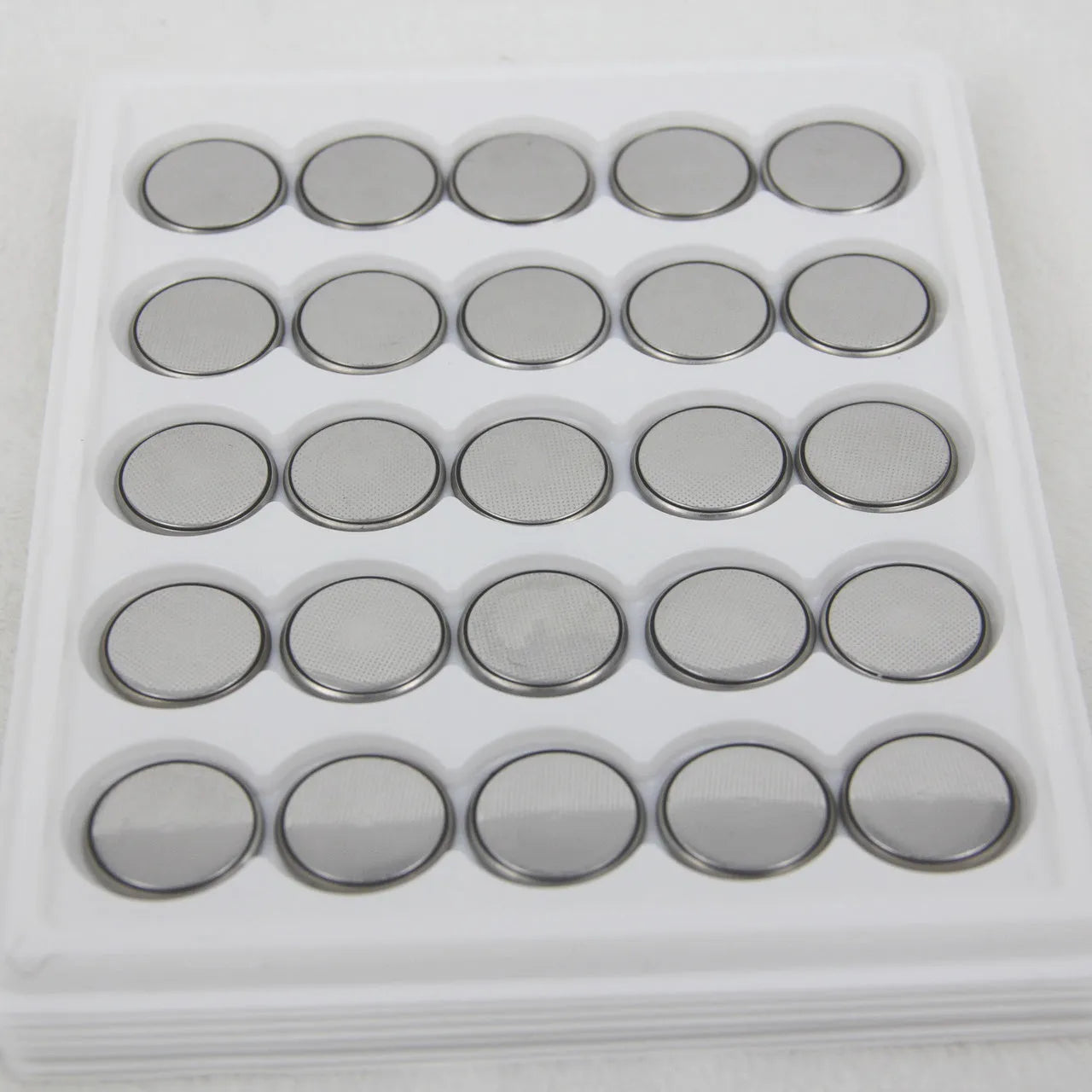 Pack of 3V alkaline button batteries showing CR2032, CR2025, and CR2016 coin cells for small electronics.