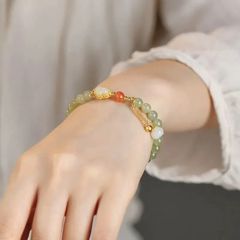 Qingshui jade bracelet with gold-plated details and a fu character on 6mm beads.
