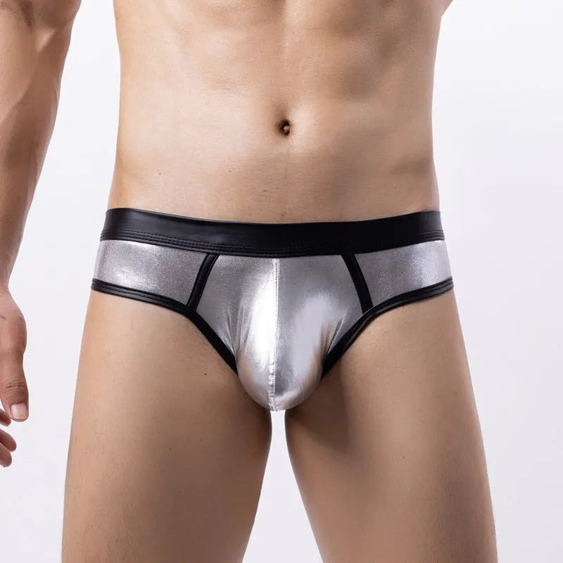 Man wearing low-waist gold bikini swim briefs on beach