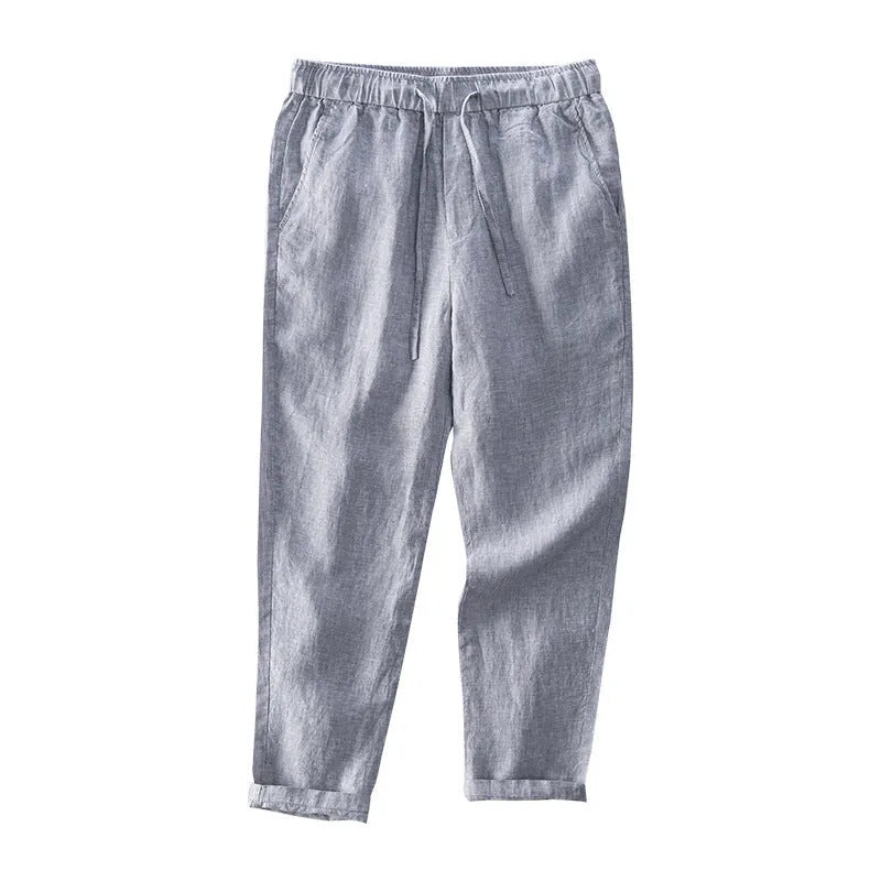 Men's straight leg linen trousers in light grey on a hanger.