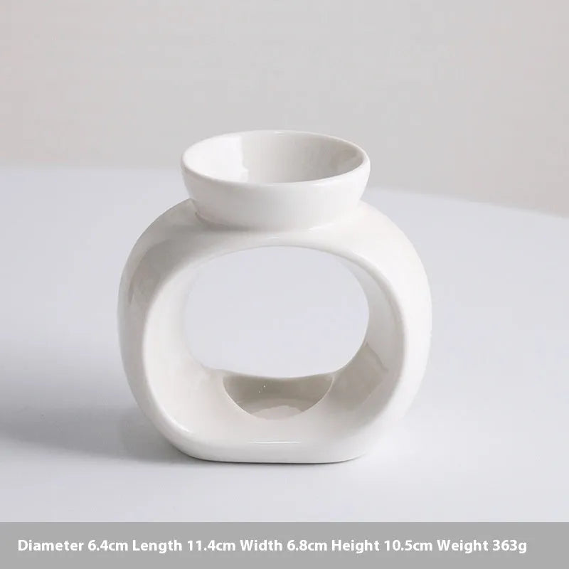 White retro Nordic ceramic aromatherapy stove ornament on a surface.