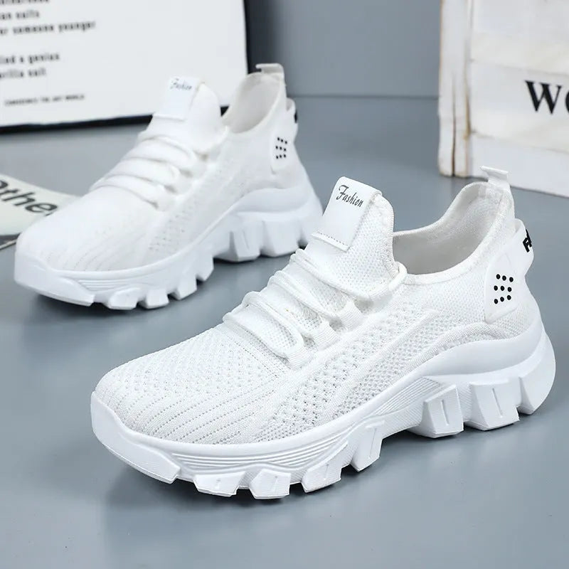 Men's white Flyknit running sneakers with thick PVC sole and lace-up front.