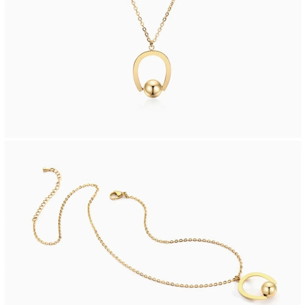 Stainless steel geometric pendant necklace on a cross chain, shown in a gold colour finish.