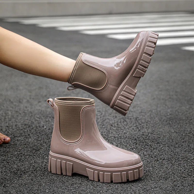 Women's creamy-white PVC low tube rain boots with flat heel and non-slip sole.